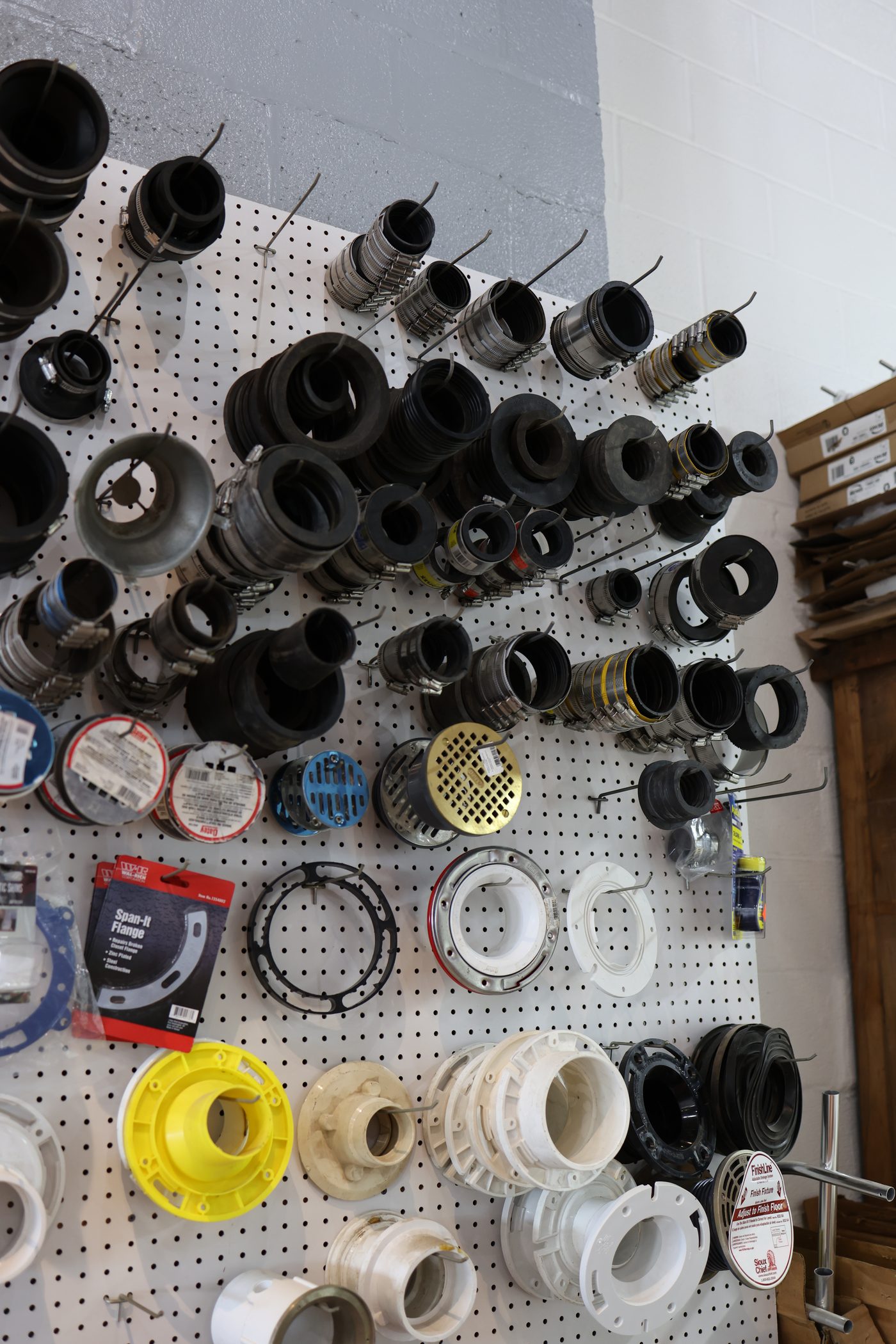 Pipe couplings and closet flanges on the shop wall