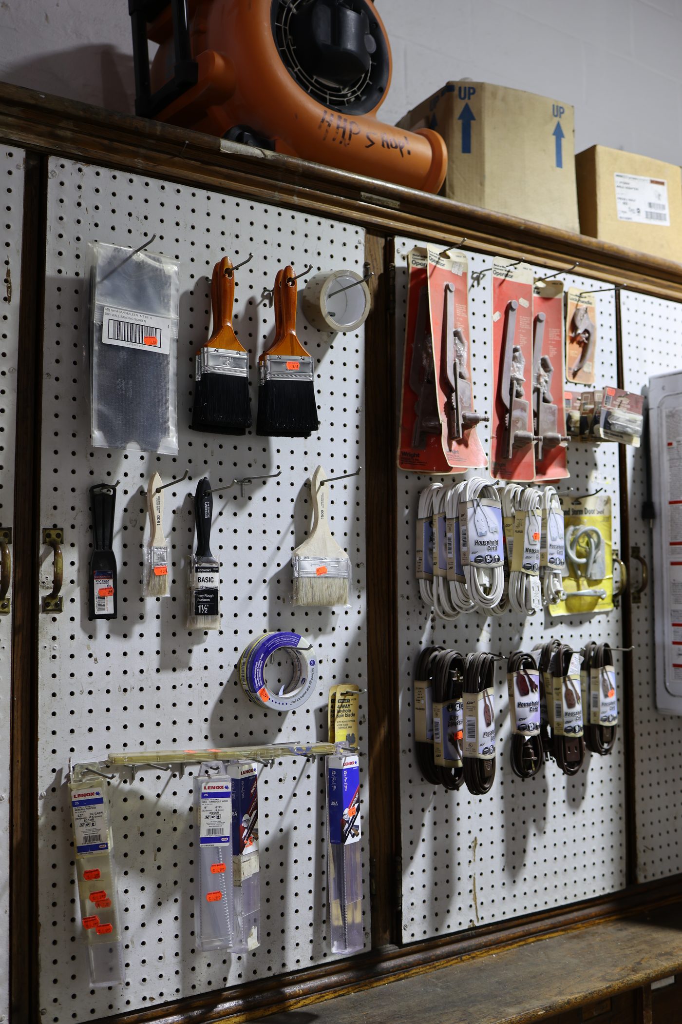 Pegboard of brushes, tape and cords at the Hertel counter